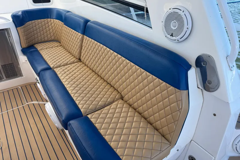  Yacht Photos Pics Luxurious seating on 2012 Intrepid 390 Sport Yacht with quilted tan and blue upholstery.