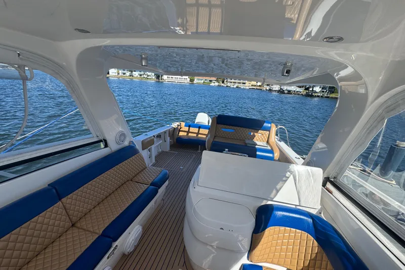  Yacht Photos Pics Luxurious 2012 Intrepid 390 Sport Yacht interior with blue and tan seating on the water.