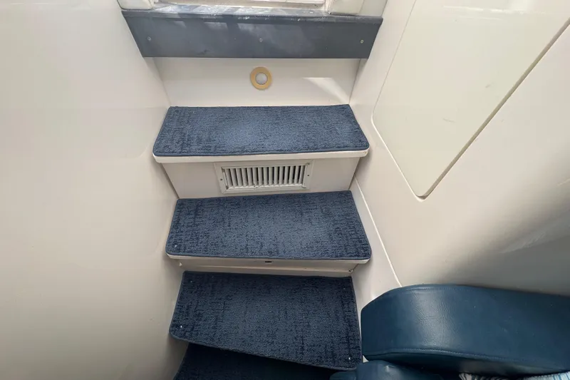  Yacht Photos Pics Interior steps of a 2012 Intrepid 390 Sport Yacht with blue carpet.