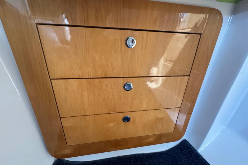  Yacht Photos Pics Wooden drawers inside a 2012 Intrepid 390 Sport Yacht, featuring sleek design and polished finish.