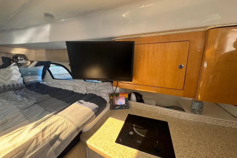  Yacht Photos Pics Interior of 2012 Intrepid 390 Sport Yacht with bed, TV, and kitchenette.