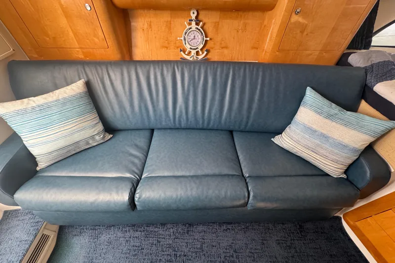  Yacht Photos Pics Blue leather sofa with striped cushions in 2012 Intrepid 390 Sport Yacht interior.