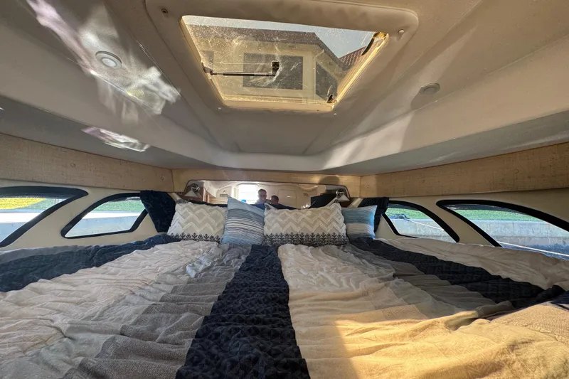  Yacht Photos Pics Interior cabin of 2012 Intrepid 390 Sport Yacht with cozy bedding and natural light.