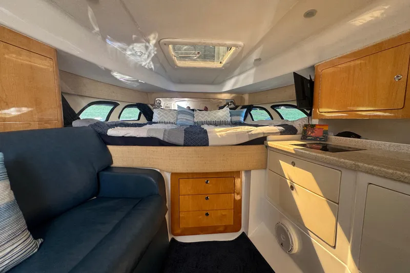  Yacht Photos Pics Interior of 2012 Intrepid 390 Sport Yacht with cozy bed and seating area.