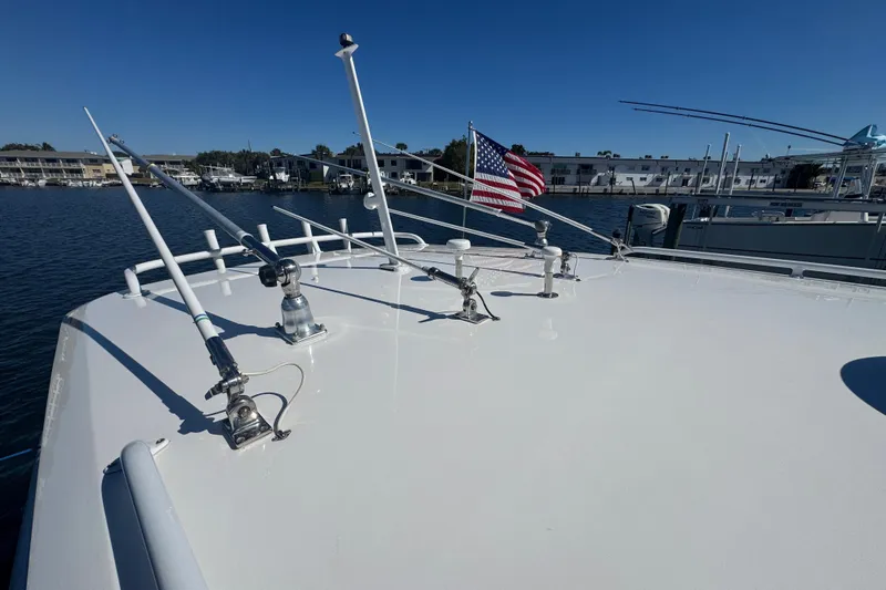  Yacht Photos Pics 2012 Intrepid 390 Sport Yacht deck with antennas and American flag, docked in marina.