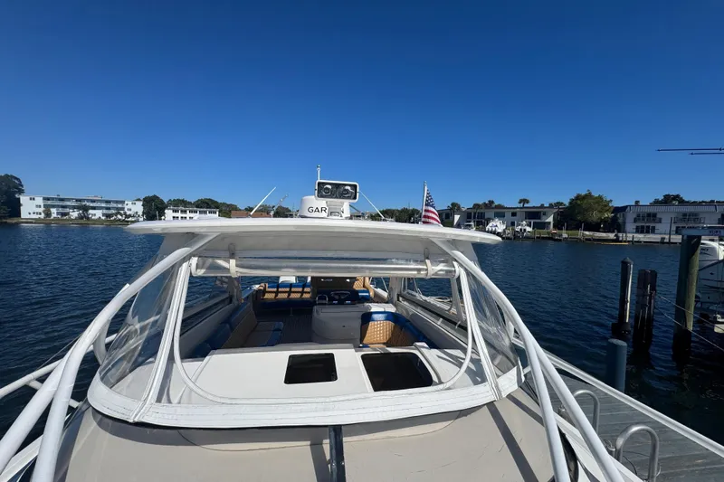  Yacht Photos Pics 2012 Intrepid 390 Sport Yacht docked, featuring spacious deck and clear canopy.
