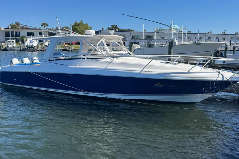  Yacht Photos Pics 2012 Intrepid 390 Sport Yacht docked in marina, blue and white design.