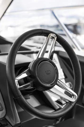 V40188 Yacht Photos Pics Steering wheel of 2024 Princess V40 yacht, featuring sleek design and modern controls.
