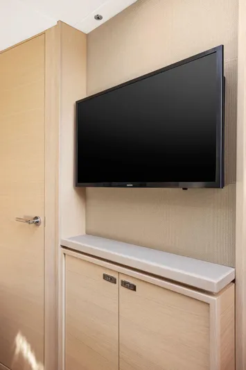V40188 Yacht Photos Pics 2024 Princess V40 yacht interior with wall-mounted TV and wooden cabinetry.