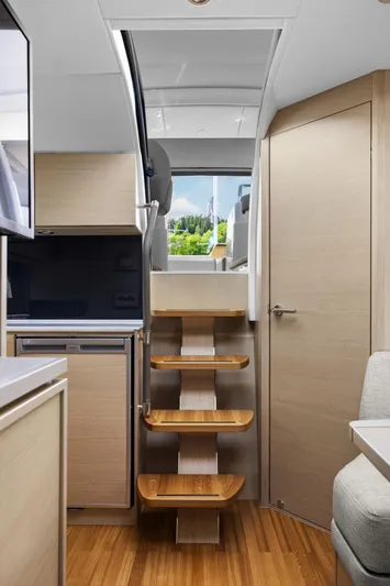 V40188 Yacht Photos Pics Interior of 2024 Princess V40 yacht with modern wooden stairs and sleek design.
