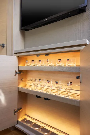 V40188 Yacht Photos Pics Luxurious 2024 Princess V40 yacht interior with illuminated glassware cabinet.