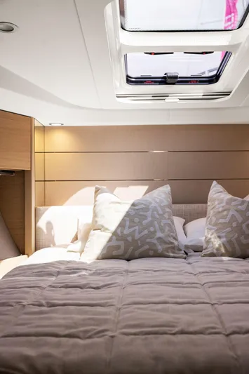 V40188 Yacht Photos Pics Luxurious 2024 Princess V40 yacht cabin with skylight and plush bedding.