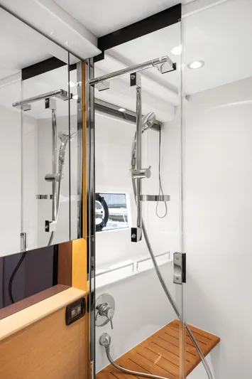 V40188 Yacht Photos Pics Luxurious shower area in 2024 Princess V40 yacht with glass doors and wooden bench.