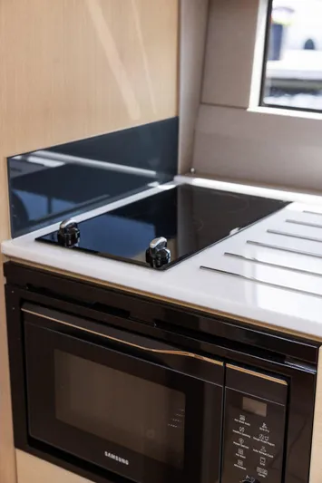 V40188 Yacht Photos Pics Modern kitchen in 2024 Princess V40 yacht with stove and microwave.