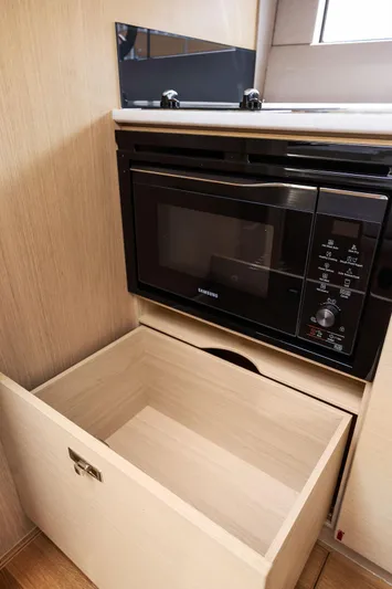 V40188 Yacht Photos Pics Modern kitchen setup in 2024 Princess V40 yacht with microwave and storage drawer.
