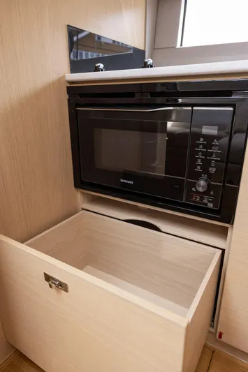 V40188 Yacht Photos Pics 2024 Princess V40 yacht kitchen with Samsung microwave and open wooden drawer.
