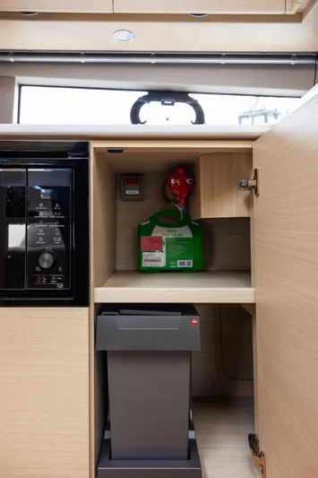 V40188 Yacht Photos Pics 2024 Princess V40 yacht interior cabinet with safety equipment and modern appliances.