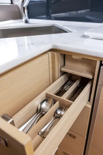 V40188 Yacht Photos Pics Modern kitchen drawer with organized cutlery in a 2024 Princess V40 yacht.