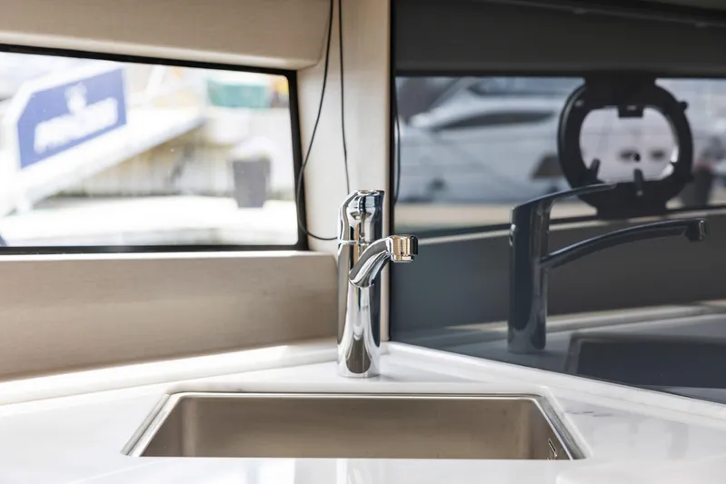 V40188 Yacht Photos Pics Modern kitchen sink on 2024 Princess V40 yacht, featuring sleek chrome faucet and elegant countertop.