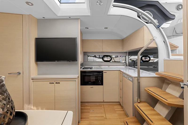 V40188 Yacht Photos Pics Modern interior of 2024 Princess V40 yacht with kitchen and wooden stairs.