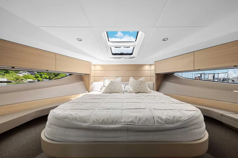 V40188 Yacht Photos Pics Luxurious 2024 Princess V40 yacht cabin with skylight, elegant bedding, and modern wood finishes.