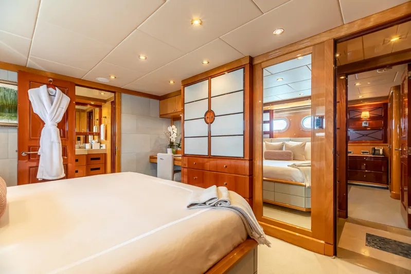 Impromptu Yacht Photos Pics Luxurious bedroom interior of 2011 Trinity Yachts CUSTOM model with wooden accents and modern amenities.