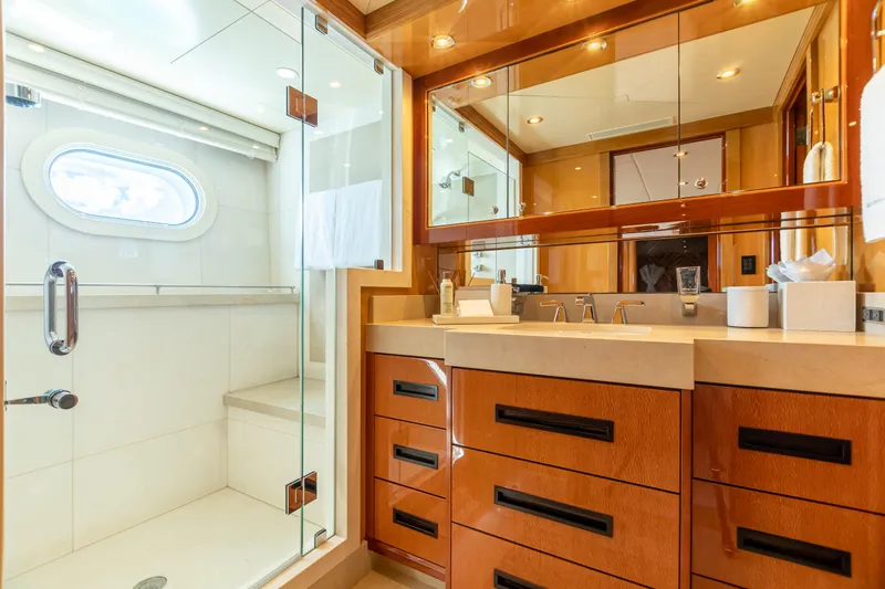 Impromptu Yacht Photos Pics Luxurious bathroom on 2011 Trinity Yachts CUSTOM with glass shower and wooden cabinetry.