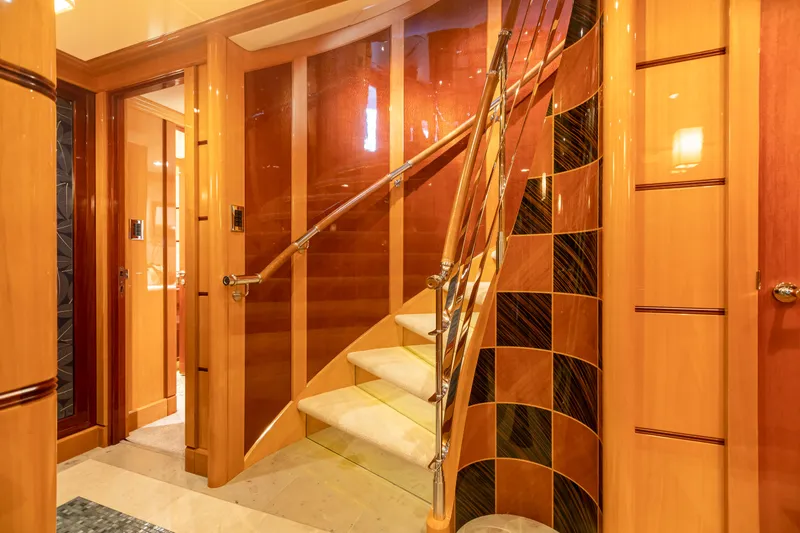 Impromptu Yacht Photos Pics Luxurious interior staircase of 2011 Trinity Yachts CUSTOM model with elegant wood and metal finishes.