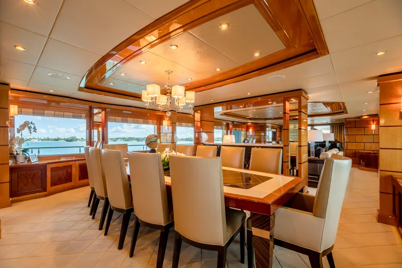 Impromptu Yacht Photos Pics Luxurious dining area on 2011 Trinity Yachts CUSTOM model with elegant furnishings and panoramic windows.