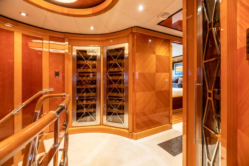 Impromptu Yacht Photos Pics Luxurious interior of 2011 Trinity Yachts CUSTOM with elegant wood paneling and wine storage.