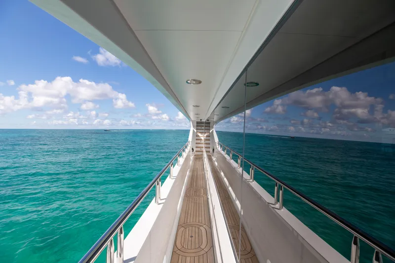 Impromptu Yacht Photos Pics Side deck view of 2011 Trinity Yachts CUSTOM yacht cruising on turquoise waters.