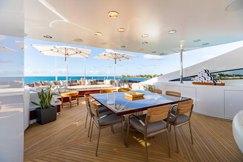 Impromptu Yacht Photos Pics Luxurious deck of 2011 Trinity Yachts CUSTOM with dining area and ocean view.