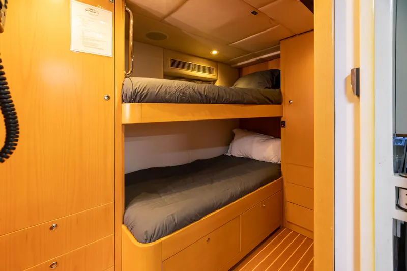 Impromptu Yacht Photos Pics 2011 Trinity Yachts CUSTOM interior with bunk beds and wooden cabinetry.