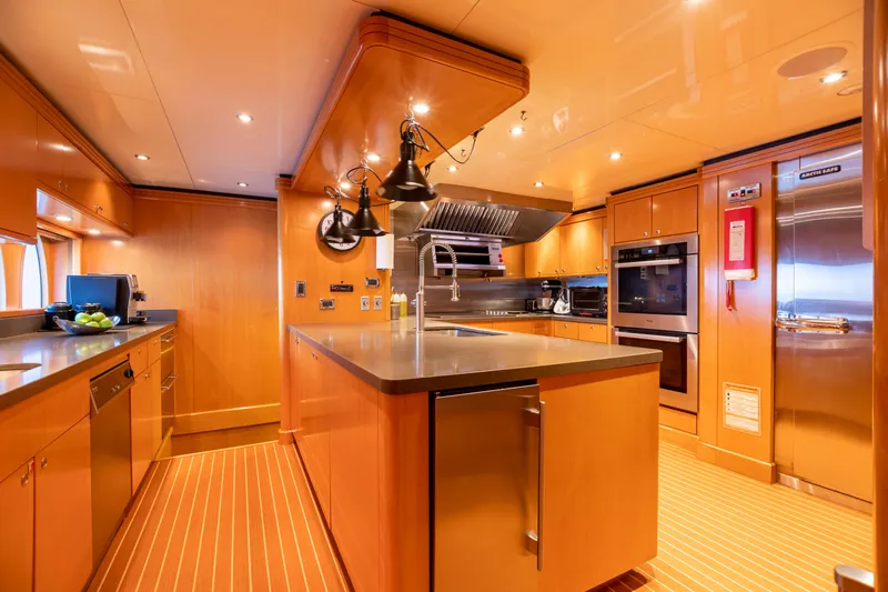 Impromptu Yacht Photos Pics Luxurious kitchen on a 2011 Trinity Yachts CUSTOM yacht with modern appliances and wooden cabinetry.