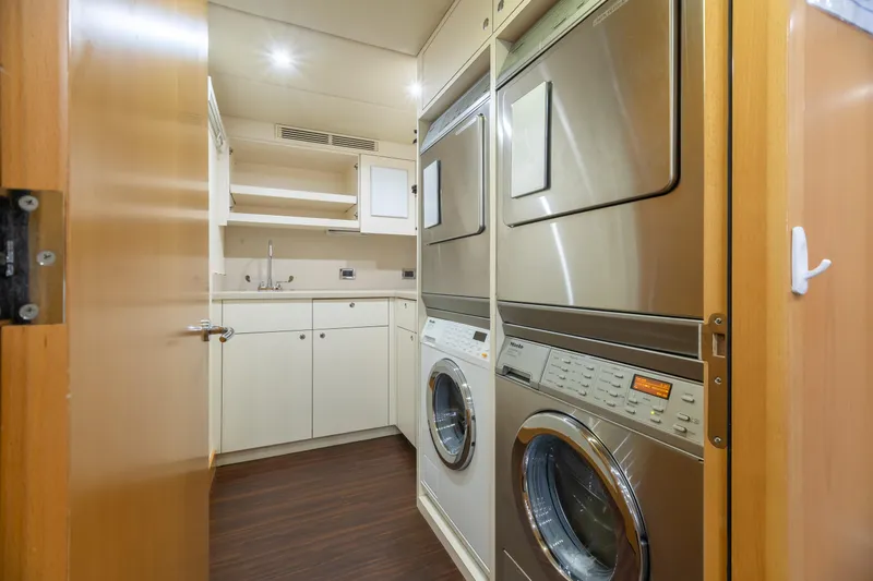 Impromptu Yacht Photos Pics Laundry room on 2011 Trinity Yachts CUSTOM with stacked washer and dryer units.
