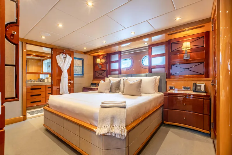 Impromptu Yacht Photos Pics Luxurious bedroom on a 2011 Trinity Yachts CUSTOM yacht with elegant wood finishes.