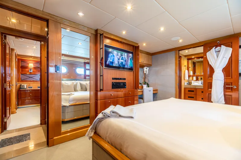 Impromptu Yacht Photos Pics Luxurious bedroom on 2011 Trinity Yachts CUSTOM with TV, ensuite bathroom, and elegant wood finishes.