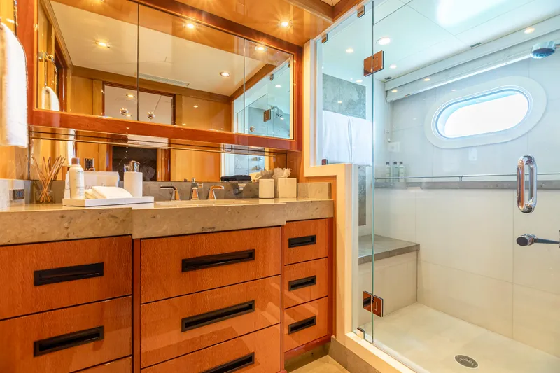 Impromptu Yacht Photos Pics Luxurious bathroom on 2011 Trinity Yachts CUSTOM with wooden cabinetry and glass shower enclosure.