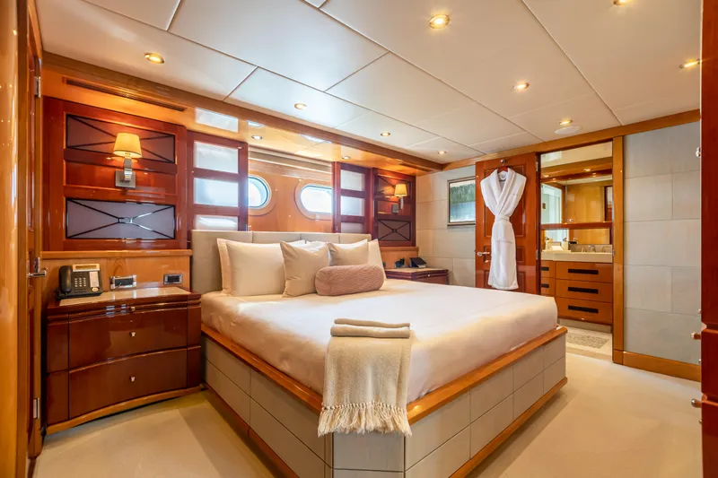 Impromptu Yacht Photos Pics Luxurious bedroom on a 2011 Trinity Yachts CUSTOM yacht with elegant wood finishes.