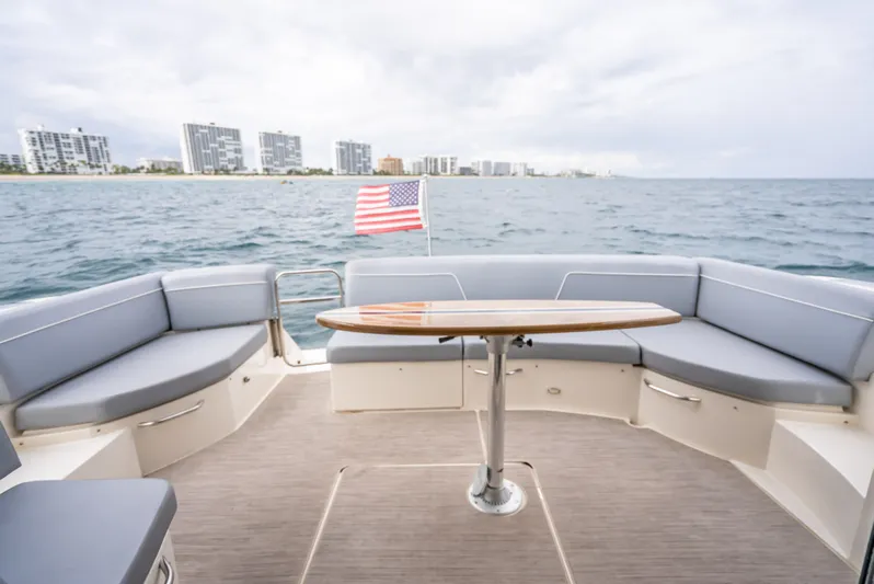 Pier Pressure Yacht Photos Pics Carver C52 Coupe 2017 with ocean view and city skyline.