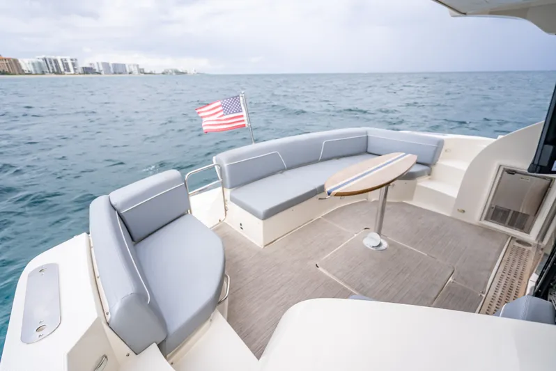 Pier Pressure Yacht Photos Pics Carver C52 Coupe 2017 yacht with seating area and table on the sea.