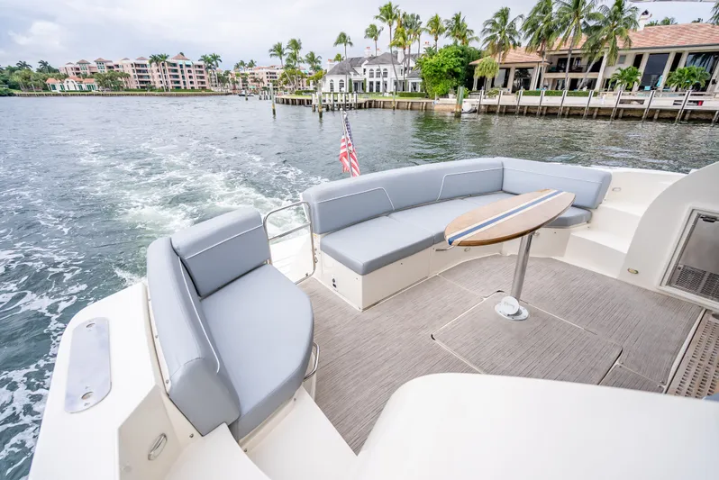 Pier Pressure Yacht Photos Pics 2017 Carver C52 Coupe with luxurious deck and seating area.