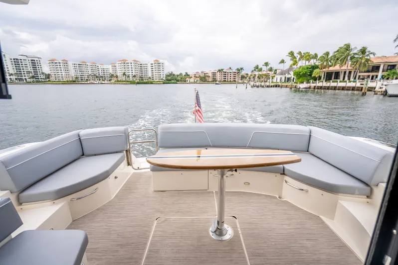 Pier Pressure Yacht Photos Pics Carver C52 Coupe 2017 with water and buildings view.