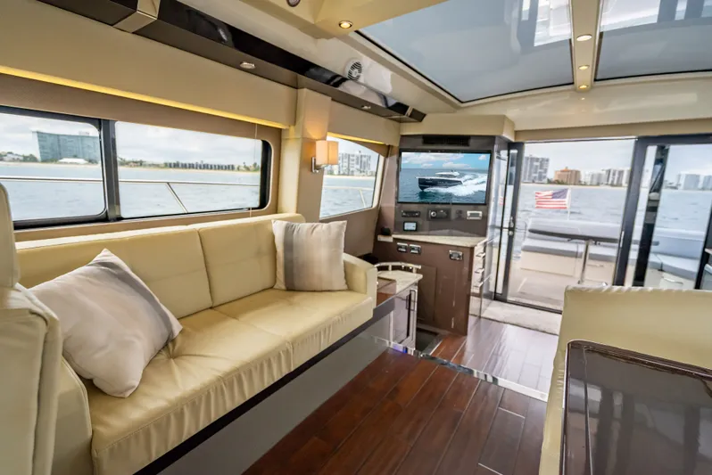 Pier Pressure Yacht Photos Pics Interior of 2017 Carver C52 Coupe yacht with luxurious sofa and water view.