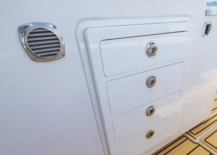  Yacht Photos Pics White storage drawers on 2021 HCB 53 Sueños boat, featuring sleek design and metallic accents.