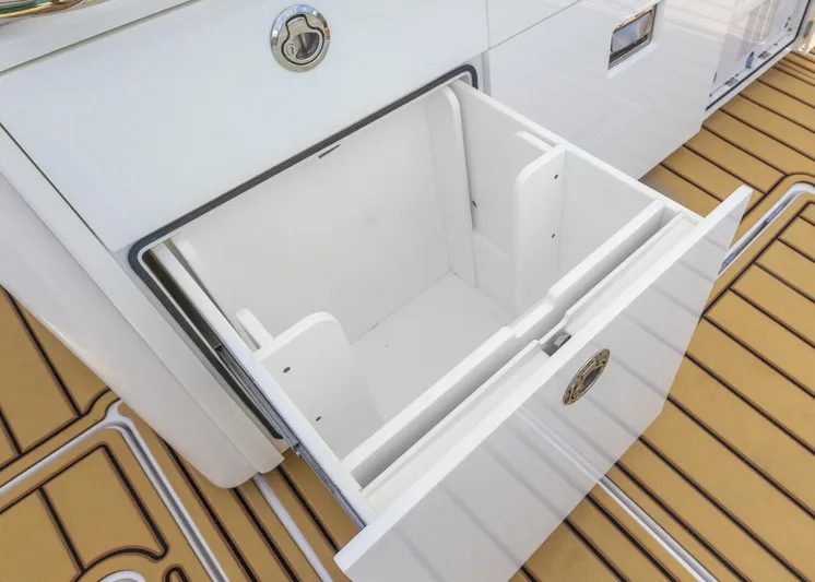  Yacht Photos Pics Open storage compartment on 2021 HCB 53 Sueños boat with teak flooring.