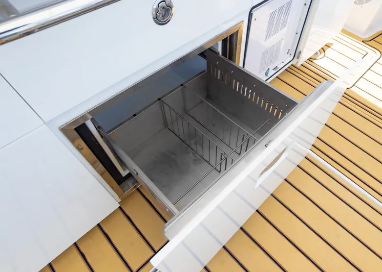  Yacht Photos Pics Open storage compartment on 2021 HCB 53 Sueños boat with wooden deck.