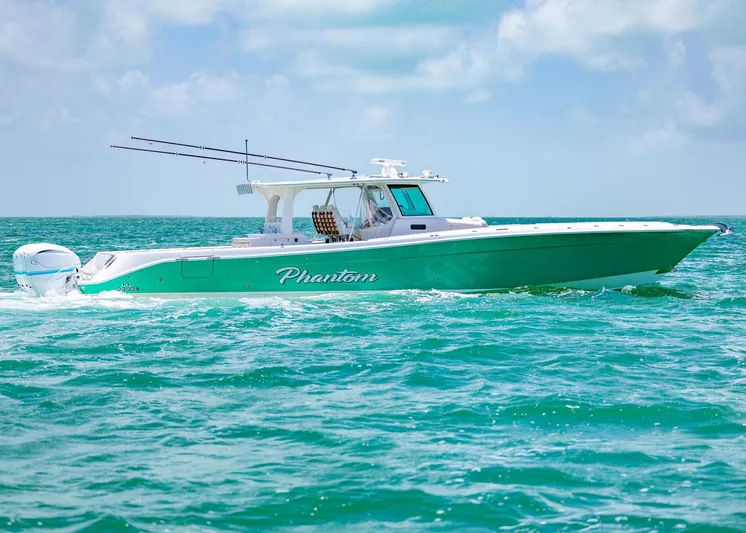  Yacht Photos Pics 2021 HCB 53 Sueños boat cruising on turquoise ocean waters under a clear sky.