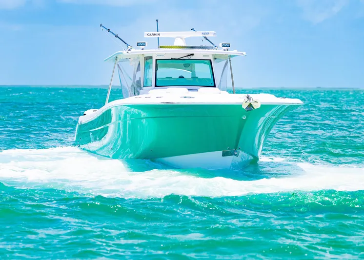  Yacht Photos Pics 2021 HCB 53 Sueños boat cruising on turquoise ocean waters.