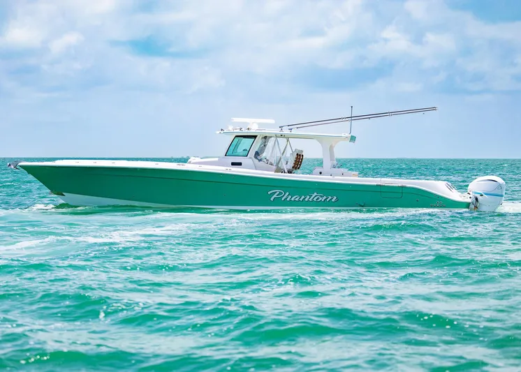  Yacht Photos Pics 2021 HCB 53 Sueños boat cruising on turquoise ocean waters under a clear sky.